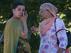 A woman wipes away a tear in front of the Sikh Temple of Wisconsin where at least one gunman stormed the mass and opened fire August, 5, 2012 Oak Creek, Wisconsin.