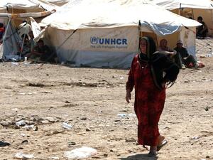 A Syrian-Kurdish woman walks at the Quru Gusik refugee camp, 20 kilometres east of the of Arbil, the capital of the autonomous Kurdish region of northern Iraq, on August 17, 2013. (AFP)