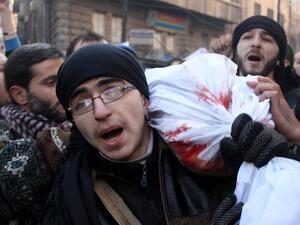 Mourners carry the body of a comrade killed during battles with members of the al-Qaeda-linked group Islamic State of Iraq and the Levant (ISIL), in the northern city of Aleppo, on January 8, 2014.