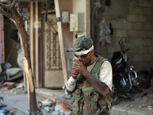 A Syrian government forces soldier lights a cigarette on July 31, 2013 in the al-Khalidiyah district of Syria's central city of Homs (AFP)