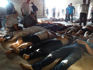 People inspect bodies of children and adults laying on the ground as Syrian rebels claim they were killed in a toxic gas attack by pro-government forces in eastern Ghouta, on the outskirts of Damascus on August 21, 2013. (AFP/Shaam News Network) 