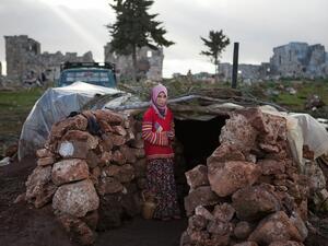 A Syrian girl stands at the entrance of a makeshift home set up in the catacombs of the ruins of a building in the ancient Roman city of of Serjilla, in northwestern Syria, on Monday. (AFP Photo/Daniel Leal-Olivas)