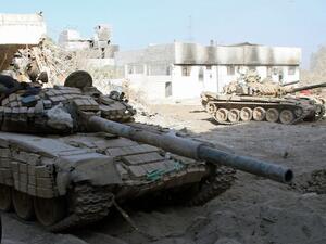 Syrian army tanks are seen deployed in the Jobar neighbourhood of Damascus on August 24, 2013. (AFP)