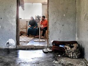 Amina and her son Bilal in their makeshift home