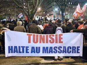 People hold a banner reading "Tunisia, stop massacre" during a demonstration against Tunisian President Zine El Abidine Ben Ali on January 11, 2011 in Paris