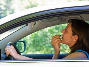 Image source: the News Tribe. Fined for applying make-up mid-driving.