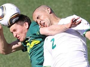 Algerian footballer clashes with an opponent on the field