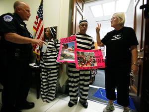 Free us 'from' the flotilla say American woman, still stranded,  who planned to free Palestine's Gaza blockade by their
 water-borne endeavor. Prisoners by American authorities in Greece. Still.
