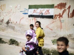 Children walk home from an improvised school in Azaz (AFP)
