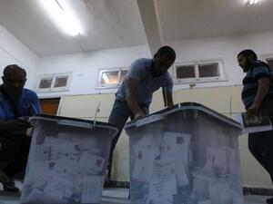 Egyptian election officials open ballot box before counting ballots at a polling station in Cairo on May 24, 2012.