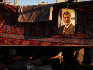 A picture of Mohamed Morsi hangs from a supporter's tent on July 10, 2013. (source: Getty / Spencer Platt)
