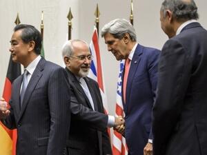 Iranian Foreign Minister Mohammed Javad Zarif, pictured here with US Secretary of State John Kerry, announced on Twitter early Sunday that a preliminary deal between Tehran and the world powers had been reached (Fabrice Coffrini/AFP)