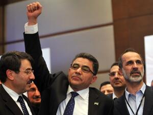 Ghassan Hitto (C), celebrates late on Monday in Istanbul with Syria's main opposition National Council chief Ahmed Moaz al-Khatib (R) after the council elected him as prime minister for swathes of Syrian rebel-held territory. (Photo: AFP/OZAN KOSE)
