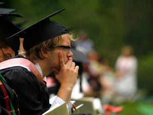 A pensive looking grad student absorbed in his own thoughts.  Maybe carrying the weight of a thesis on his shoulders might 
attract him to prayer.