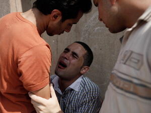 A man mourns after the July 8 shootings near Cairo's Republican Guard club. (source: Ed Giles / Getty)