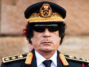 Colonel Gaddafi's wardrobe must be a treat to play dress-up with, one would imagine, going by the spectacle of color and variety, and tent-like cloths.