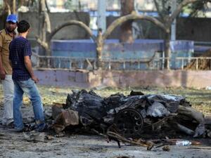  Iraqi men inspect the site of an explosion on September 4, 2013 that took place the previous day in Baghdad. Al Qaeda's Iraqi faction, the Islamic State of Iraq and the Levant, has taken responsibility for the attacks. (AFP)