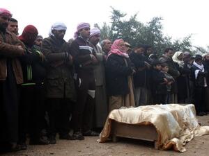 A family gathers to pray over the body of one of their relatives who was killed this weekend in clashes in Fallujah (AFP)
