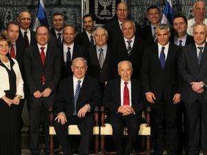Israeli President Shimon Peres (C-R, seated) sits next to Prime Minister Benjamin Netanyahu (C-L, seated) as they pose for a group photo with the ministers of the new Israeli government in Jerusalem on Monday. (Photo: AFP PHOTO/POOL/RONEN ZVULUN) 