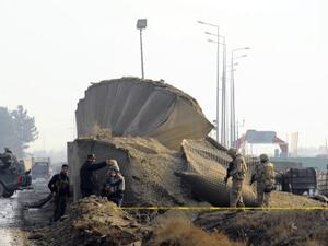 Soldiers guard the site where a Taliban suicide bomber detonated a car bomb earlier this week near the Kabul airport (Aref Karimi/AFP)