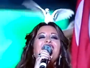 The funny moment a dove landed on Latifa's head. (Image: YouTube screenshot)