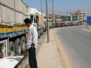 Dozens of trucks line up at the Lebanese-Syrian border in Masnaa.
