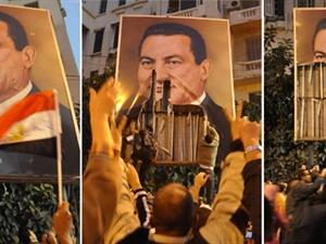 متظاهرون في الاسكندرية يمزقون صورا عملاقة لمبارك/أ.ف.ب