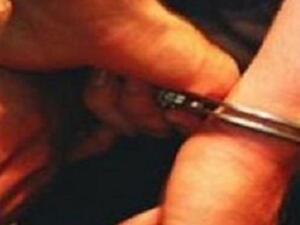 A prisoner in handcuffs.