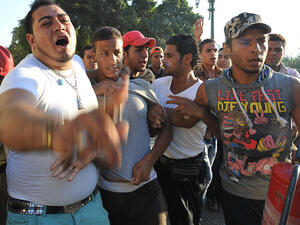 Pro-government and army supporters detain a supporter (C) of deposed Egyptian President Mohamed Mursi during clashes that erupted in Tahrir Square (AFP/FAYEZ NURELDINE)