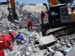 صورة التقطت خلال جولة تحت اشراف السلطات لعمال اغاثة يتفقدون حطام مبان في صرمان غرب طرابلس