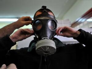 A soldier tries on a gas mask.