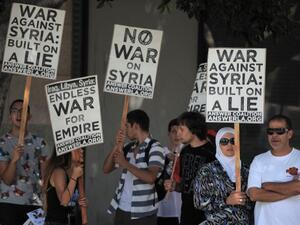 People demonstrate against a US-led strike on Syria in downtown Los Angeles on August 31, 2013. (AFP)