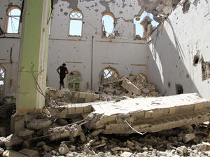 A man stands in the rubble of the Othman mosque, in Syria's eastern town of Deir Ezzor, on July 24. AFP / KARAM JAMAL