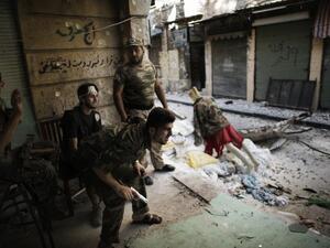 Free Syria Army fighters man a position in the city of Aleppo on Sept. 16, 2012. [AFP]