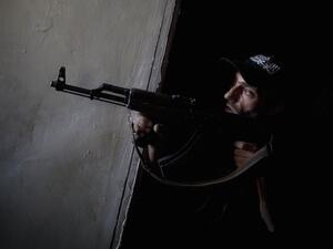 A rebel fighter points his gun towards pro-government forces' positions during clashes in the Salaheddine district of the northern Syrian city of Aleppo, on July 9, 2013. (Source: AFP/JM LOPEZ)