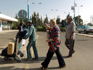A foreign national walks towards the departure area of Sanaa International Airport before leaving Yemen (AFP/MOHAMMED HUWAIS) 