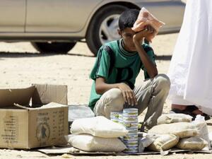 A Syrian refugee boy sits on the side of the road at Zaatari refugee camp in Jordan (AFP)