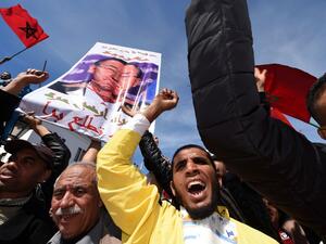 This file photo taken on March 13, 2016 shows Moroccan protesters holding placards and shouting slogans in the capital Rabat, during a demonstration against statements made by the United Nations chief earlier in the week regarding the Western Sahara, a disputed territory between Morocco and the Polisario Front, following his visit to a camp for refugees from the territory. (AFP/Fadel Senna)