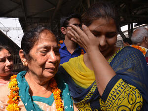 Indian resident Santosh is met by relatives after being evacuated following an earthquake in Nepal at the railway station in Amritsar on April 27, 2015. (AFP/Narinder Nanu)