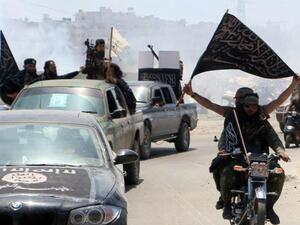 Fighters from al-Qaeda's Syrian affiliate al-Nusra Front drive in the Syrian city of Aleppo flying flags. (AFP/File)