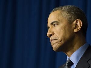 US President Barack Obama reacts during a press conference at the Organization for Economic Co-Operation and Development Centre in Paris on December 1, 2015. (AFP/Jim Watson)