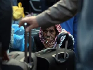 Palestinians wait to cross the border at the Rafah crossing between Egypt and Gaza. (AFP/File)