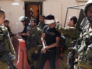 This file photo shows a Palestinian man arrested by Israeli soldiers in the occupied West Bank. (AFP/File)