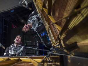 Palestinian-Syrian pianist Aeham Ahmad, known as the 'Pianist of Yarmouk,' performs at a Berlin concert hall on May 12, 2016.  Ahmad, who gained fame for performing outdoors in Damascus' Palestinian refugee camp Yarmouk, fled Syria in 2015 after Daesh militants torched his piano. (AFP/John McDougall)