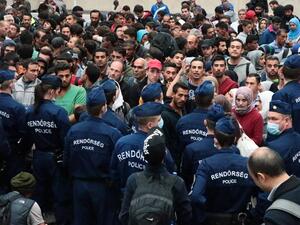 Police officers block migrants in order to prevent them from overcrowding trains at Keleti (East) railway station in Budapest on Sept. 10, 2015. (AFP/Farenc Isza)