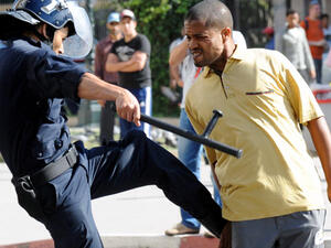A police officer kicks a demonstrator during a protest in Rabat, Morocco. (AFP/File)