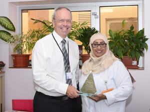 Ms. Ghaya Al Tamimi and Dr. Steven Beaumont, Rumailah Hospital, HMC, with their NDNQI award