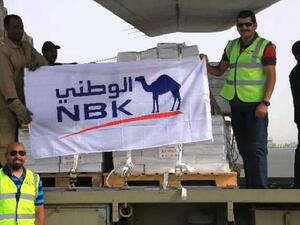 NBK staff in front of the cargo plane to Somalia
