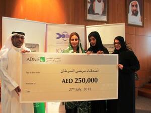 Ameera Bin Karam, President of Board of Trustees and founding member of FOCP, received the donation from Ahmed Al Riyami, the Head of Retail Business Development of ADNIF