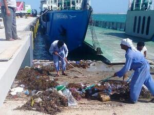 ADPC workers in action cleaning the Mugharrag Port in the Western Region ADPC workers in action cleaning the Mugharrag Port in the Western Region